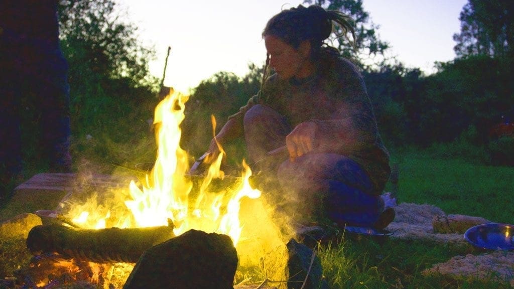 Lucie, our multi-talented horse whisperer, prepares dinner over a campfire