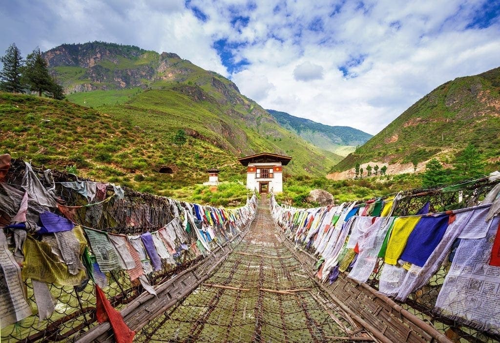 Walking suspension-bridge with colourful prayer flags on the Druk Path Trek