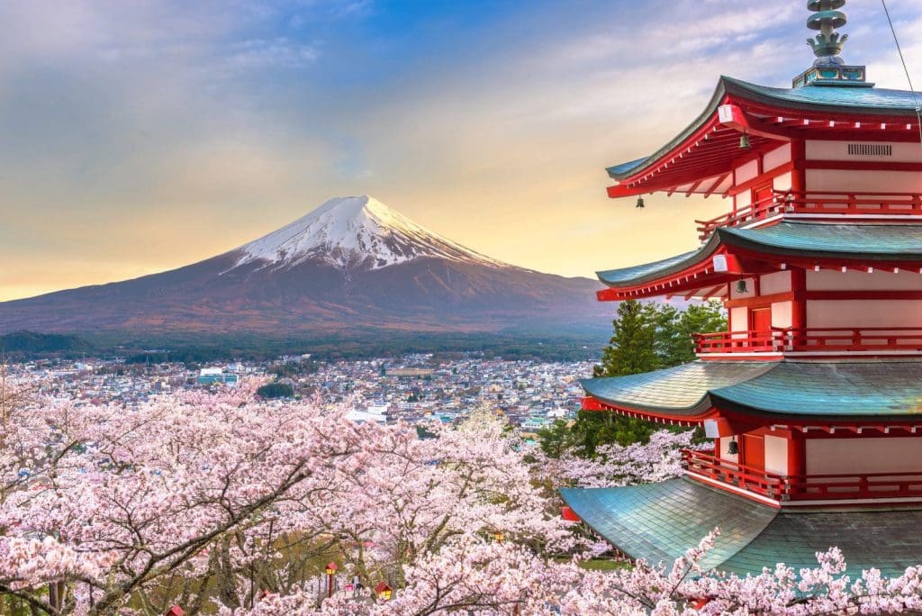 Fujiyoshida, Japan with Mt. Fuji and Chureito Pagoda at dusk during spring cherry blossom season.