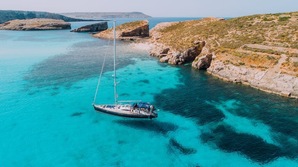 Aerial of Yacht in Blue Lagoon, off Comino