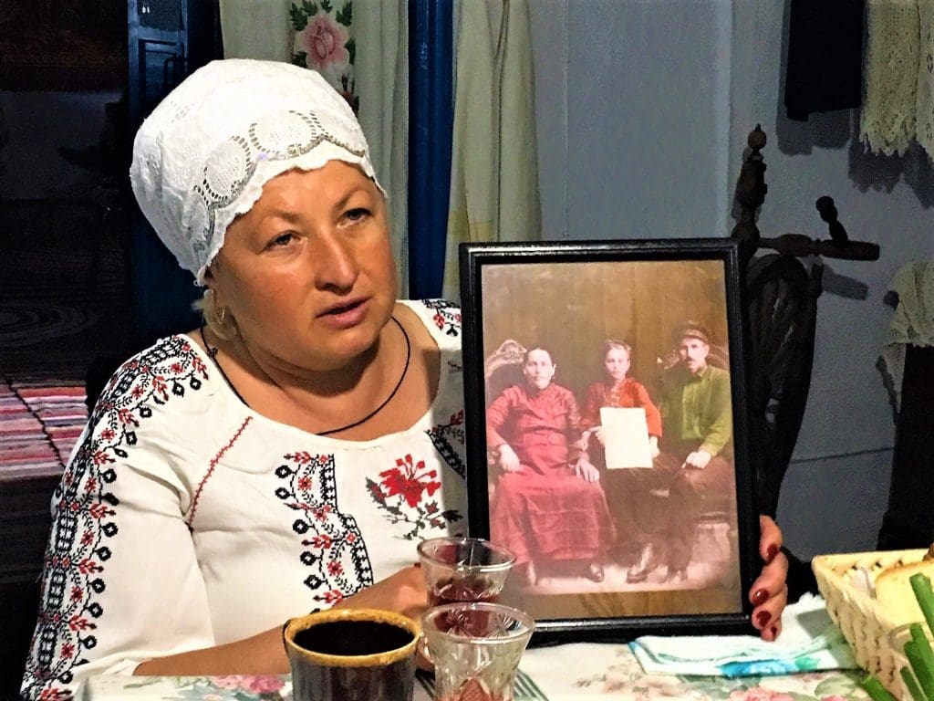 Angelica with a photograph of her grandmother pregnant with her mother taken in the 1930s
