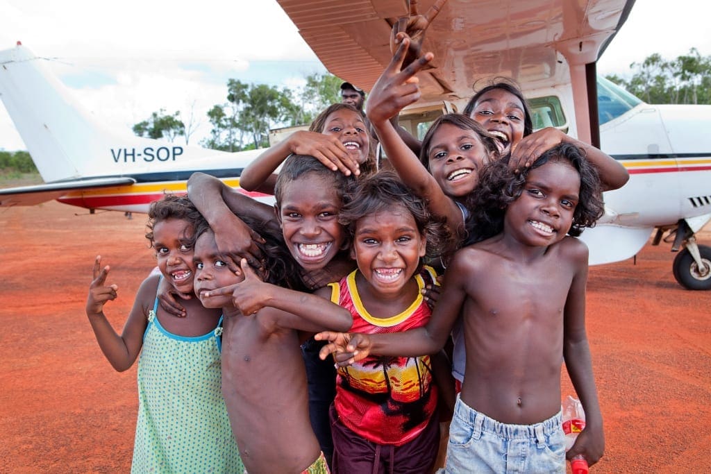 Portrait of group of Aboriginal children before boarding a flight back to their homeland at Nyinyikay's airstrip.