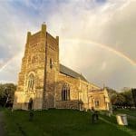 A rainbow hovering above St Bartholomew's Orford