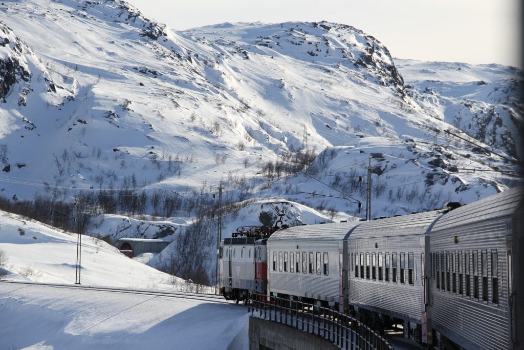 Train to Narvik in winter passing by mountains