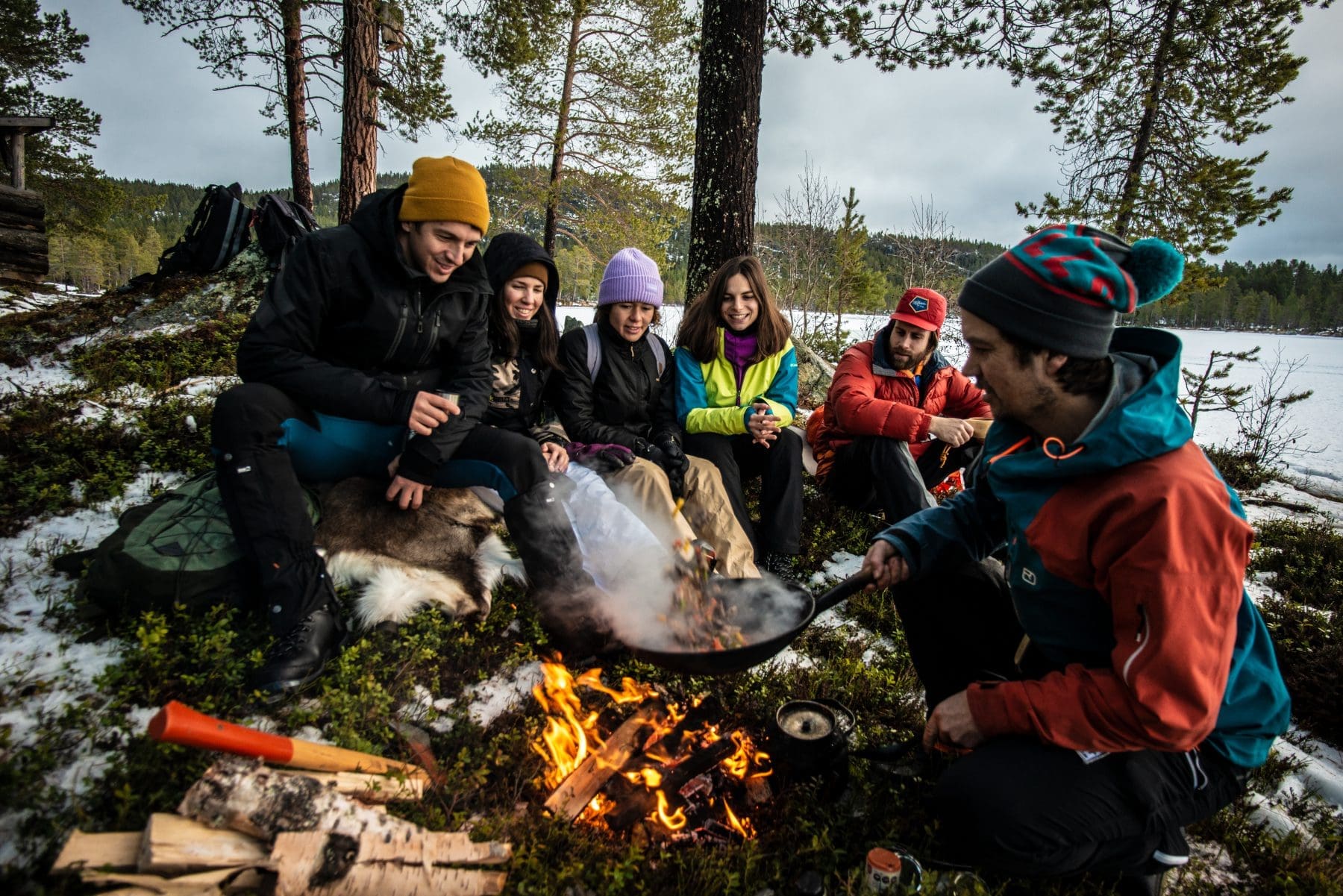 Guide and chef making an outdoor lunch for guests in Sweden. Copyright Slow Adventure Ltd