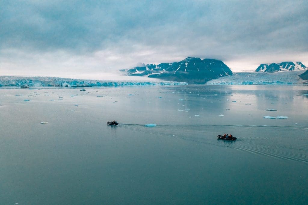 Secret Atlas Zodiac cruising near glacier, Svalbard