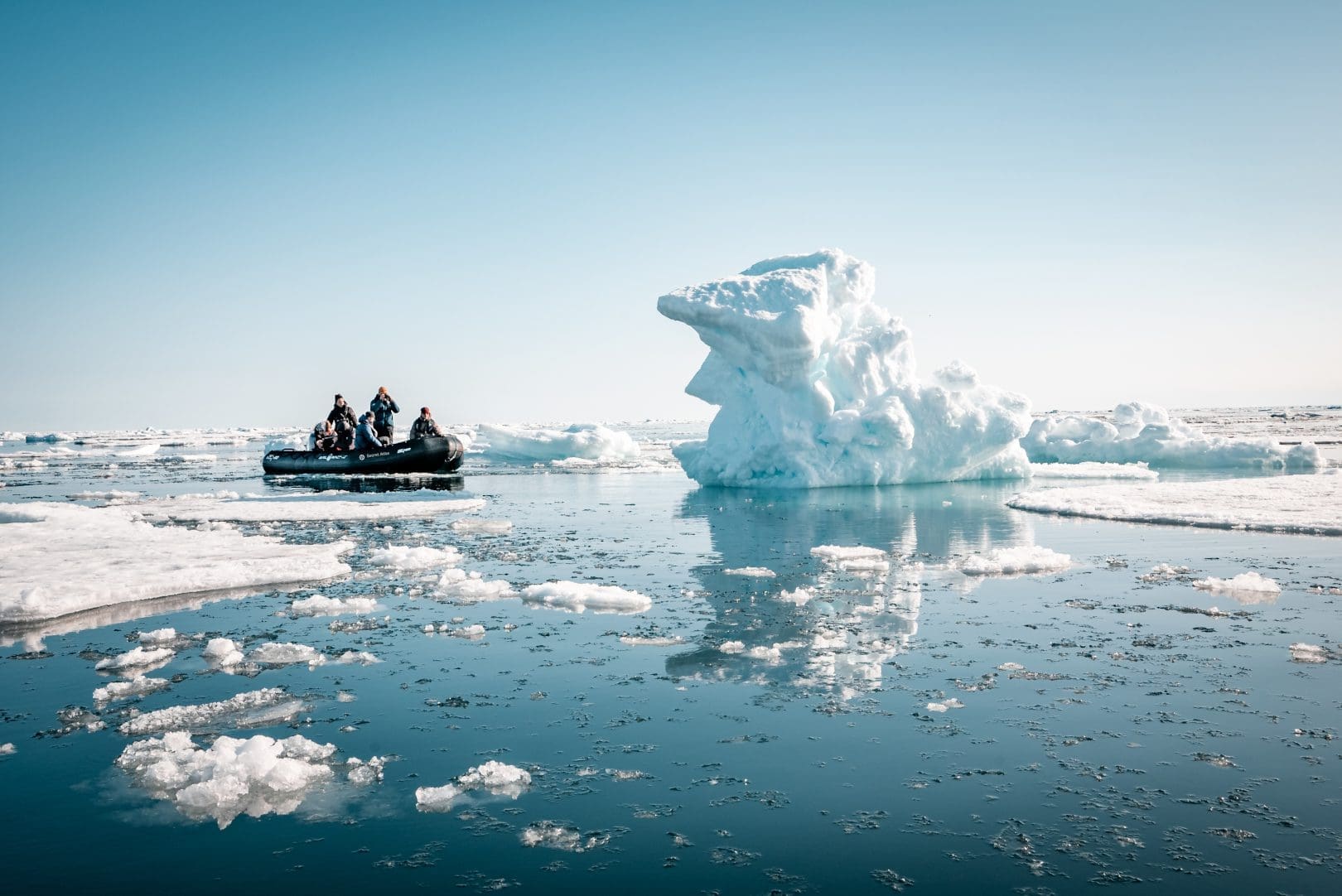 Secret Atlas Zodiac cruising near glacier, Svalbard