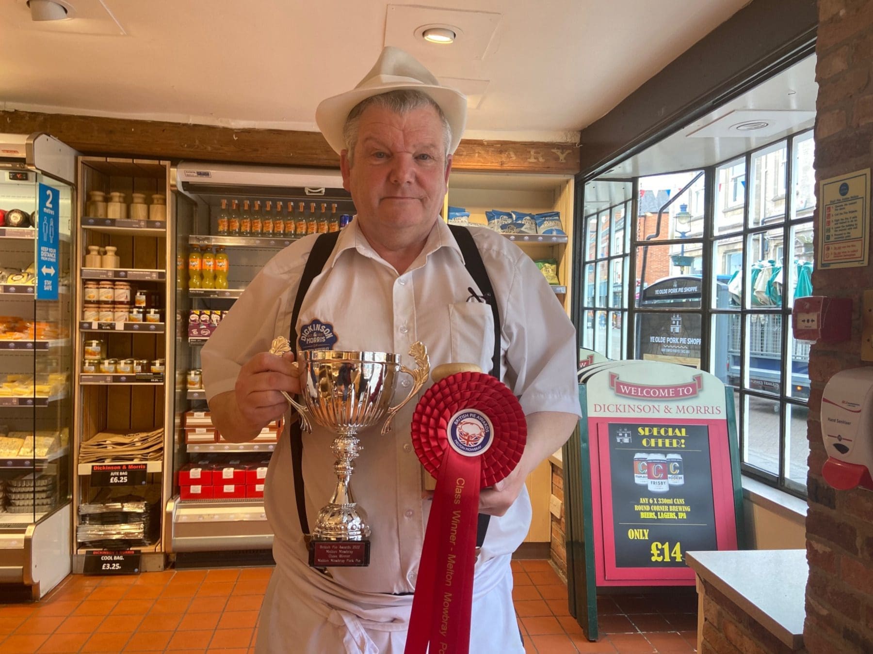 Matthew, GM of Dickensian & Morris displaying their pork pie prices