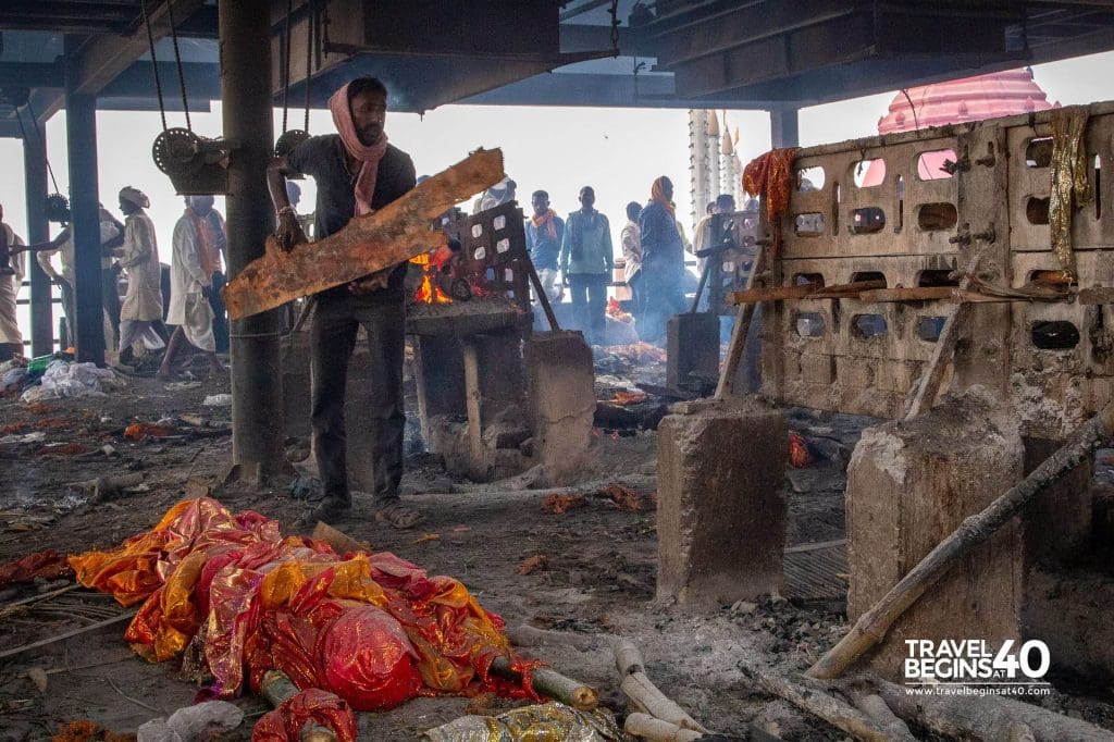 The work never ends. Preparing a pyre for the next cremation. Burning Ghats