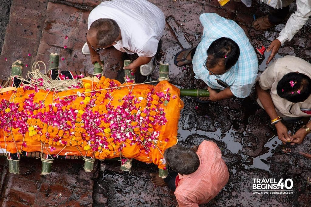 Carrying the body of a relative to the river