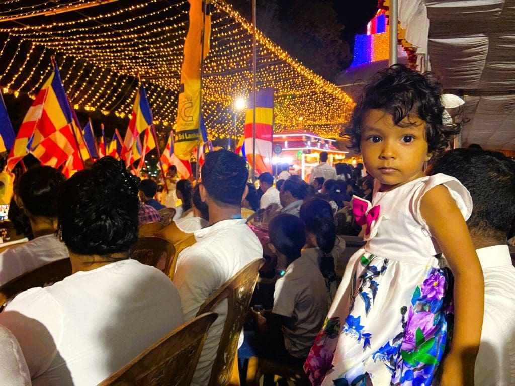 A little girl enjoying the Poson Festival at night