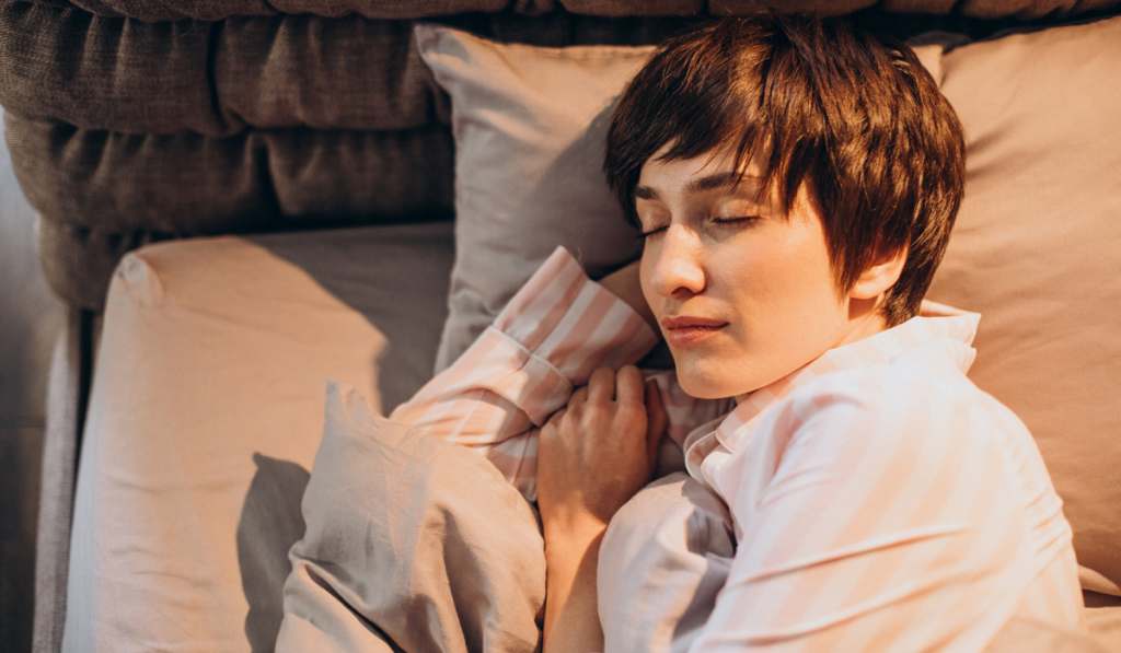 Woman sleeping peacefully in cosy bedroom